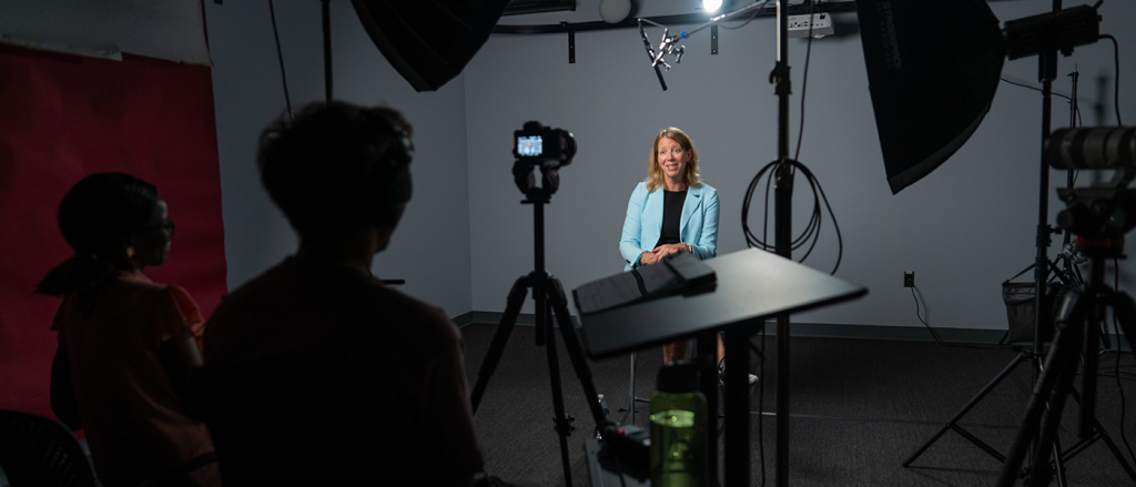 A member of McMaster's visual team and a member of McMaster's Human Resources team sit behind a camera as they interview Dean of Science Maureen MacDonald.